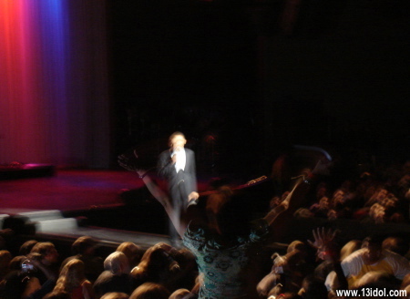As Barack Obama speaks, a lone woman leaps up with her hands in the air